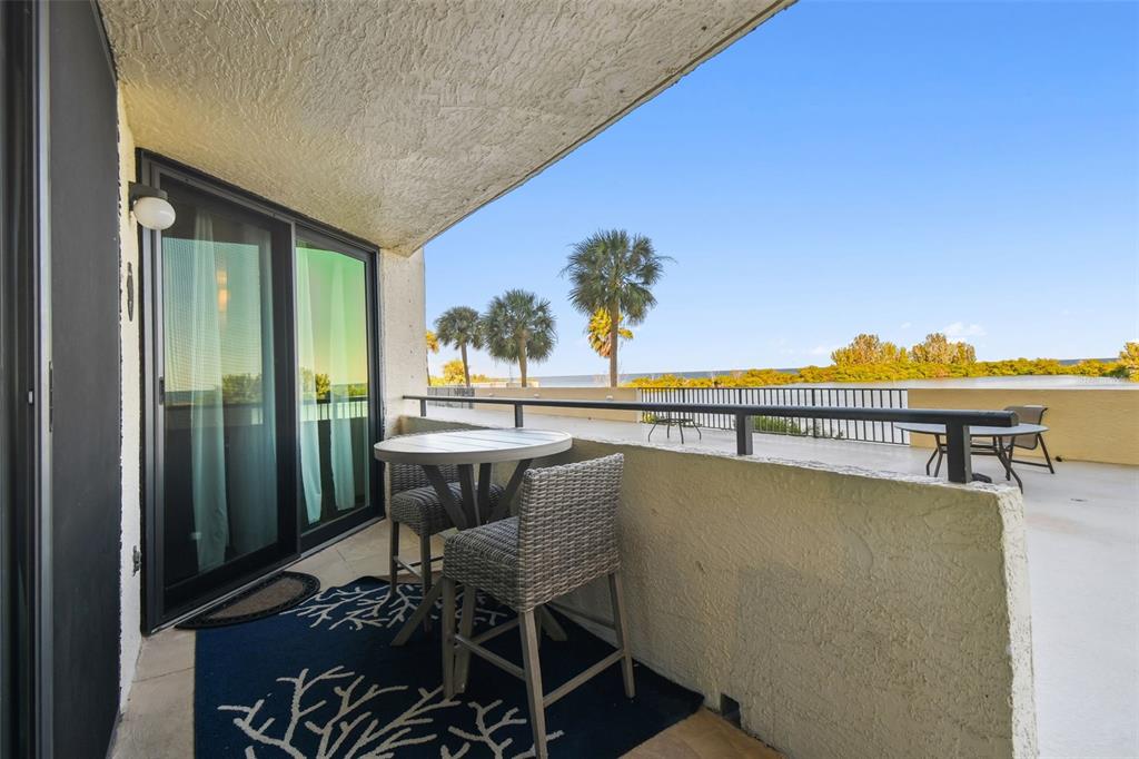 5915 Sea Ranch Drive, Unit 108 Hudson, FL 34667 - Photo 22 of 92 a balcony with furniture and city view