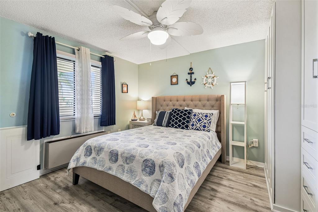 5915 Sea Ranch Drive, Unit 108 Hudson, FL 34667 - Photo 33 of 92 a bedroom with a large bed and a chandelier