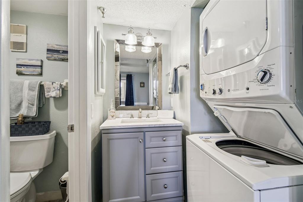 5915 Sea Ranch Drive, Unit 108 Hudson, FL 34667 - Photo 36 of 92 a utility room with cabinets washer and dryer