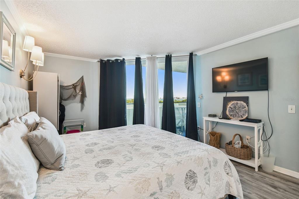 5915 Sea Ranch Drive, Unit 108 Hudson, FL 34667 - Photo 39 of 92 a bedroom with a bed and a flat screen tv