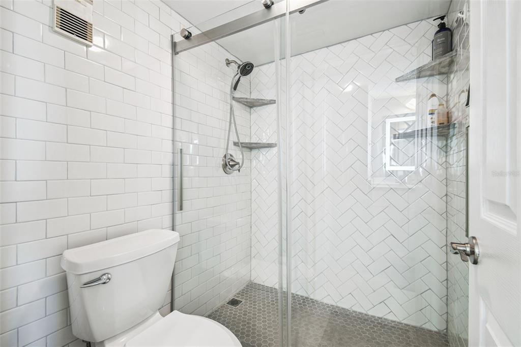 5915 Sea Ranch Drive, Unit 108 Hudson, FL 34667 - Photo 42 of 92 a bathroom with a toilet and shower