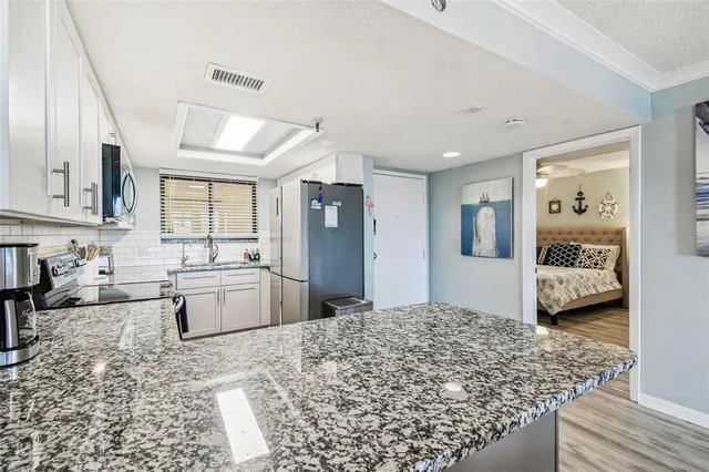 a kitchen with granite countertop a sink and a window
