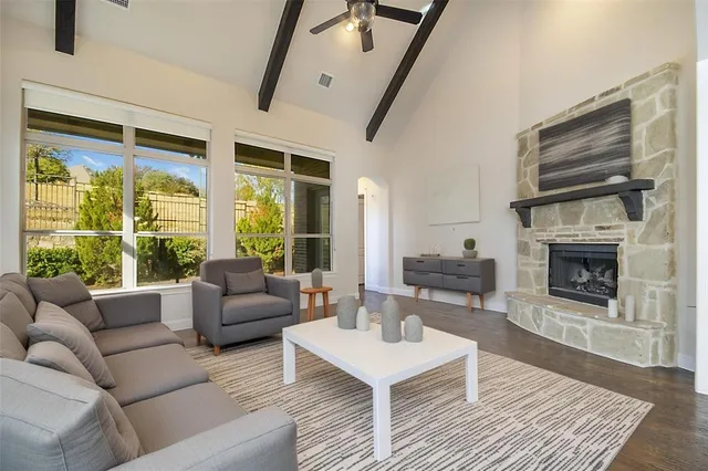 a living room with furniture large window and a fireplace