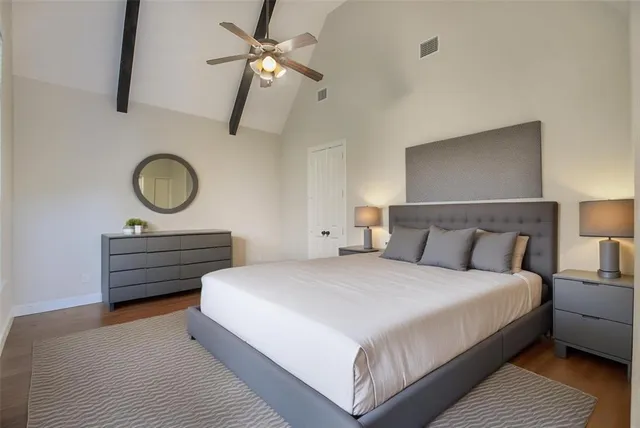 a bed room with a bed and a chandelier