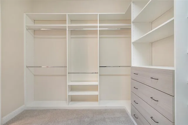 a view of walk in closet with empty racks