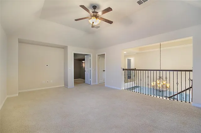 a view of a livingroom with a ceiling fan and window