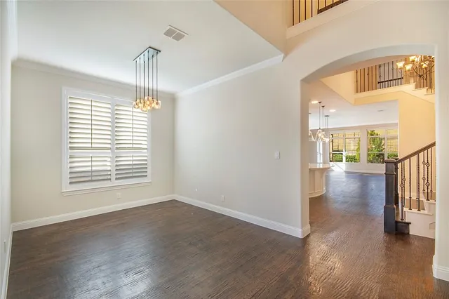 a view of a room with wooden floor water view and windows