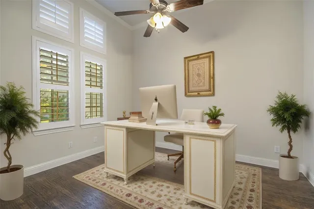 a view of a workspace with a window and wooden floor