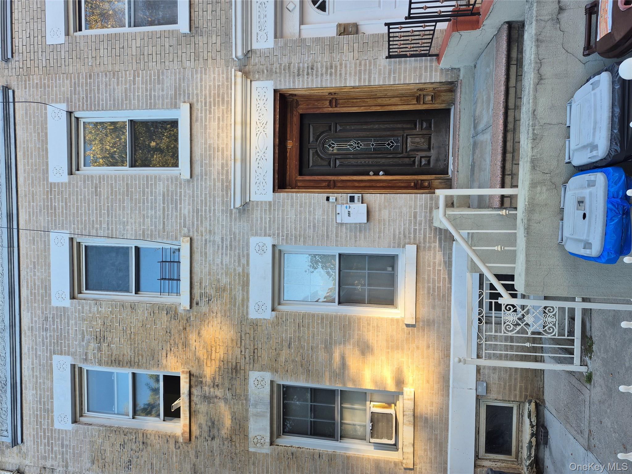 Doorway to property featuring brick siding