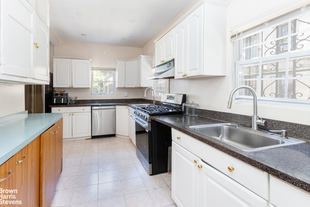 1917 Glenwood Road Brooklyn, NY 11230 - Photo 8 of 22 a kitchen with granite countertop a sink stove and cabinets