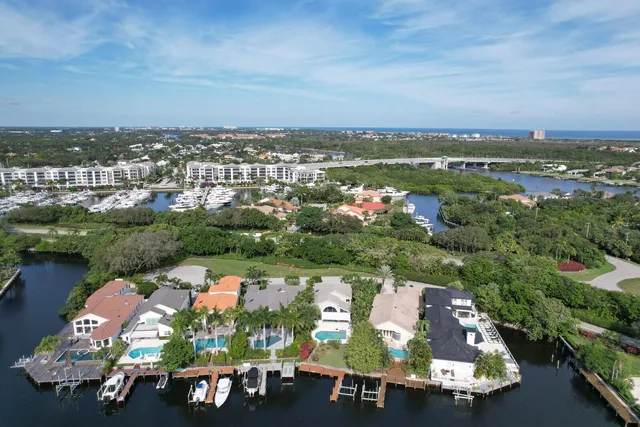 a front view of a house with a yard and mountain