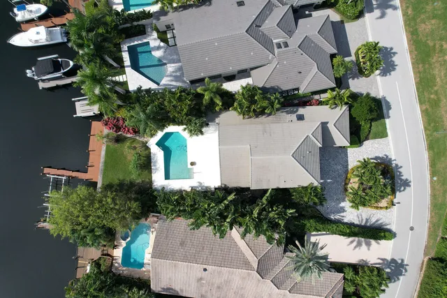 an aerial view of residential house with outdoor space and trees