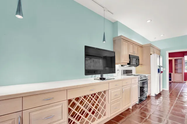 a kitchen with stainless steel appliances a microwave and cabinets