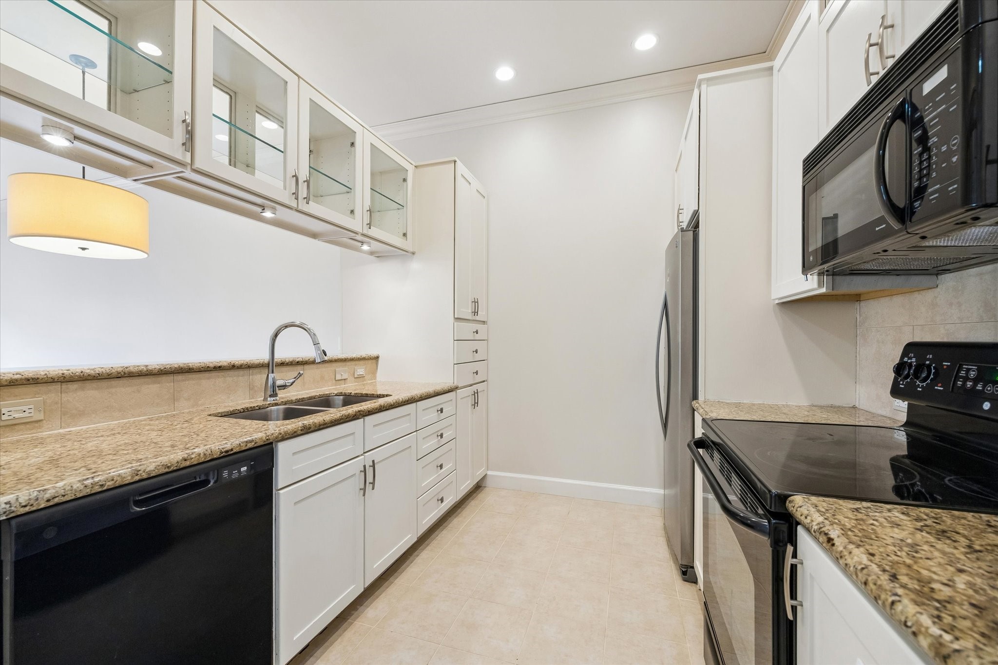 100 Willard Street, Unit 15 Houston, TX 77006 - Photo 10 of 25 Granite counters, updated cabinetry, stainless appliances, and generous prep space make this kitchen both practical and inviting for everyday cooking.