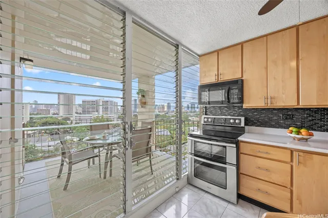 a kitchen with granite countertop a stove and cabinets