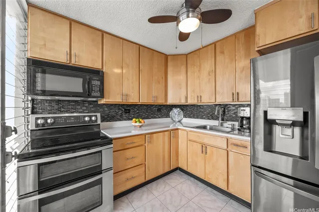 a kitchen with a sink stainless steel appliances and cabinets