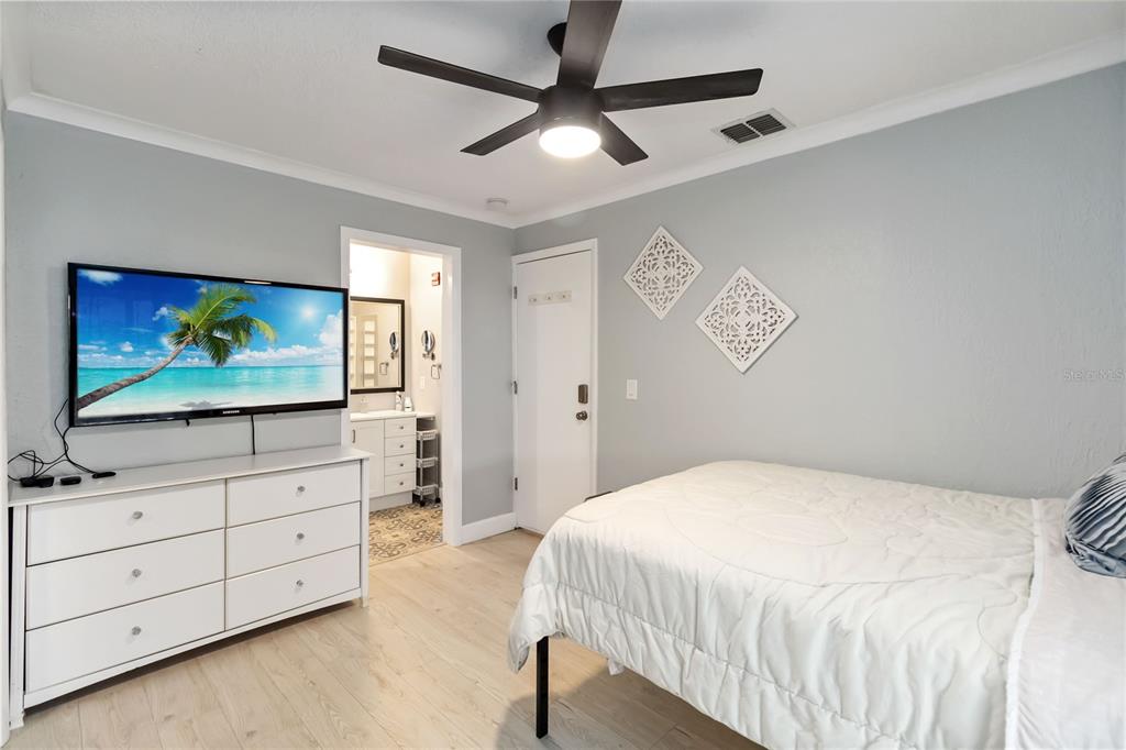 395 Piney Ridge Road Casselberry, FL 32707 - Photo 15 of 34 a bedroom with a bed and a flat screen tv