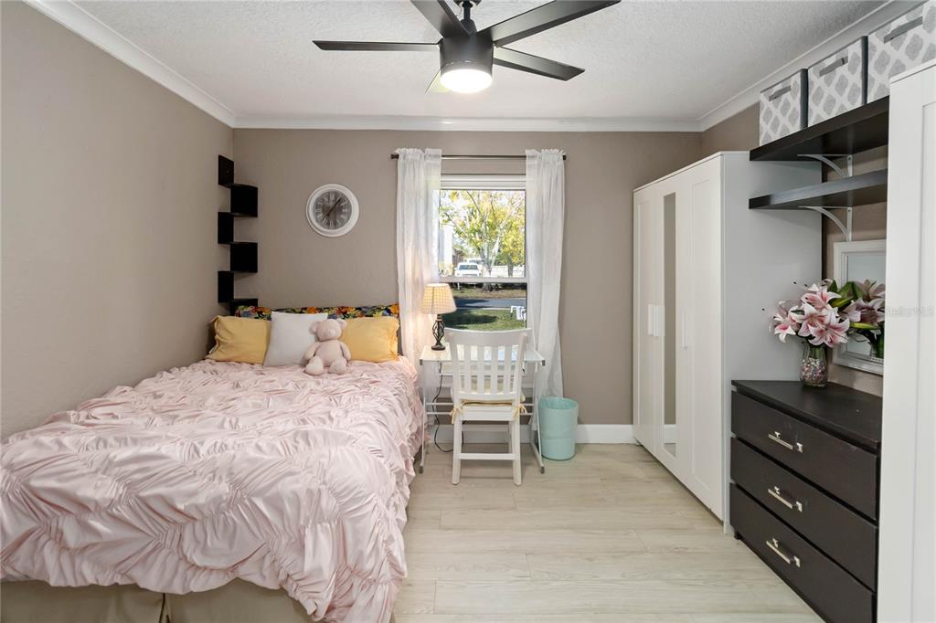 395 Piney Ridge Road Casselberry, FL 32707 - Photo 17 of 34 a bedroom with a bed and a chandelier