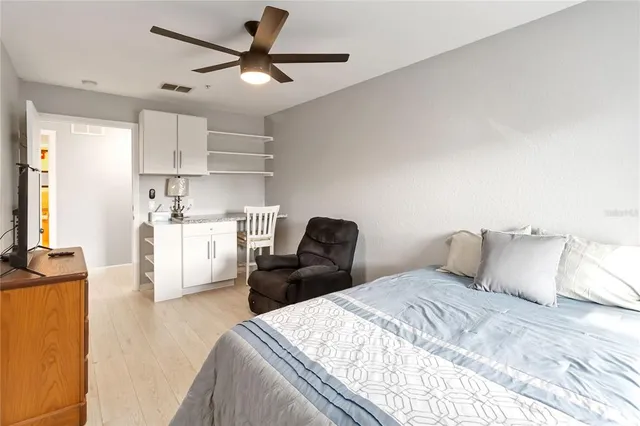 a bedroom with a bed and a chandelier