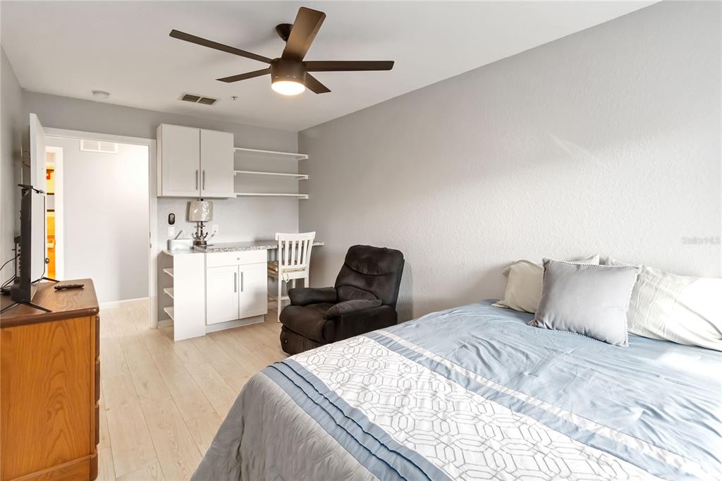 395 Piney Ridge Road Casselberry, FL 32707 - Photo 20 of 34 a bedroom with a bed and a chandelier