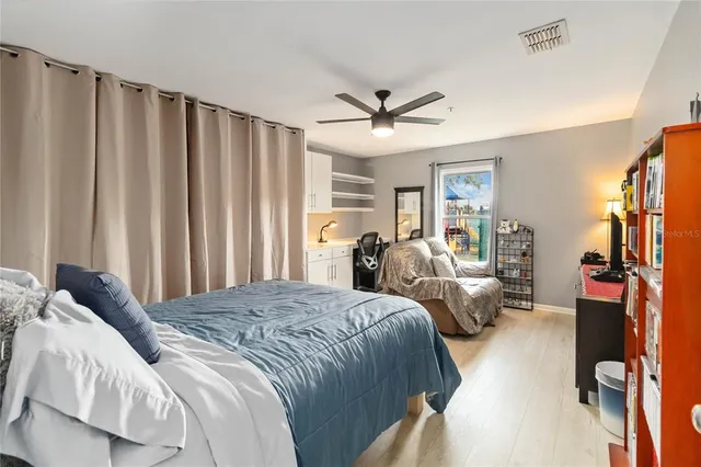 a spacious bedroom with a bed and a walk in closet