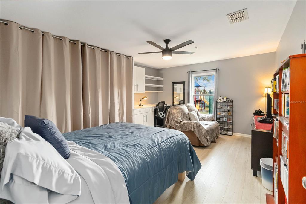 395 Piney Ridge Road Casselberry, FL 32707 - Photo 23 of 34 a spacious bedroom with a bed and a walk in closet