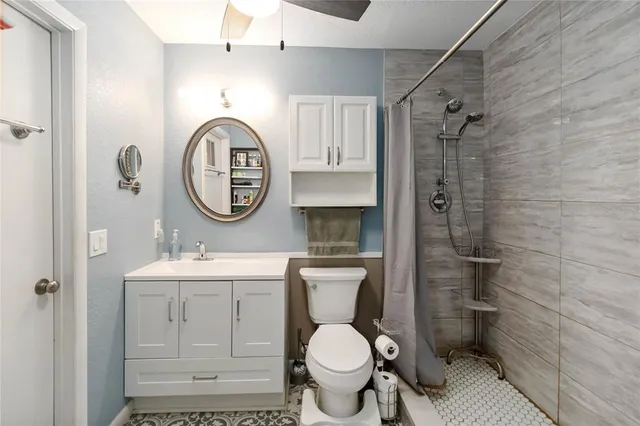 a bathroom with a toilet a sink and a mirror