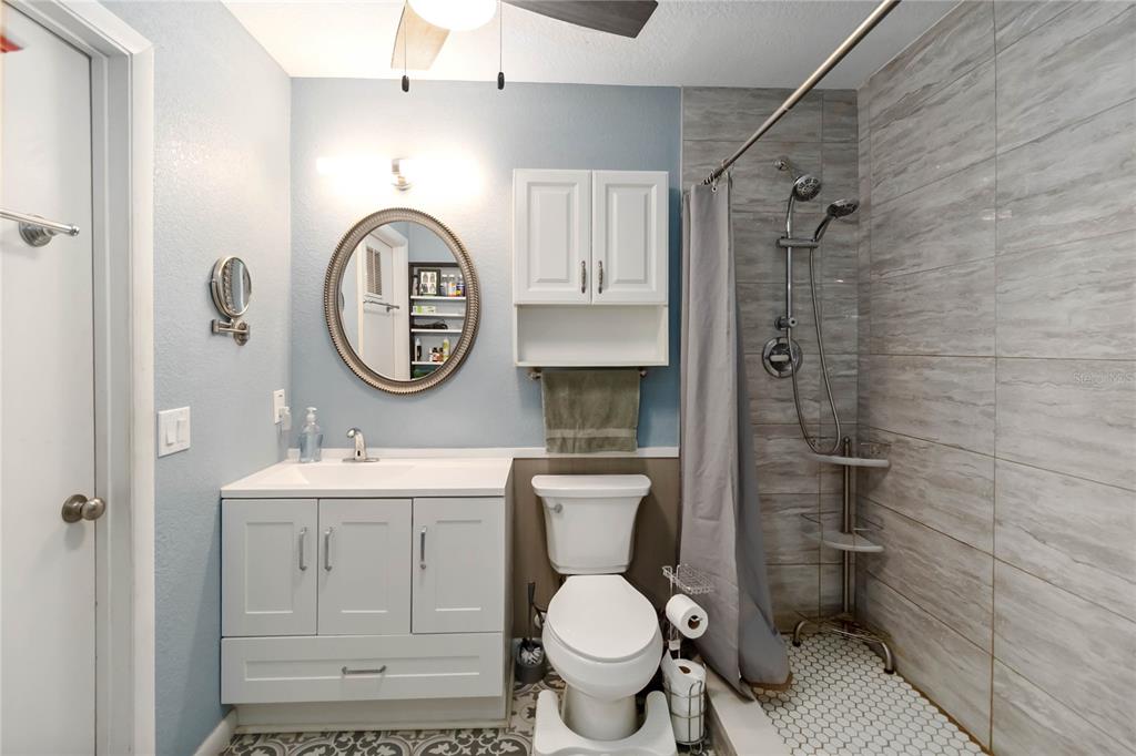 395 Piney Ridge Road Casselberry, FL 32707 - Photo 25 of 34 a bathroom with a toilet a sink and a mirror