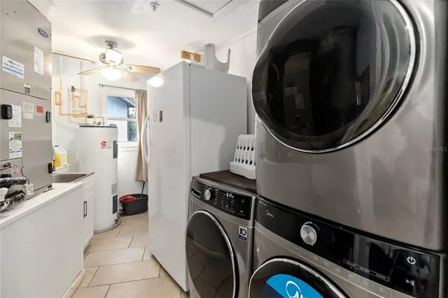 a view of a storage and utility room with dryer and washer