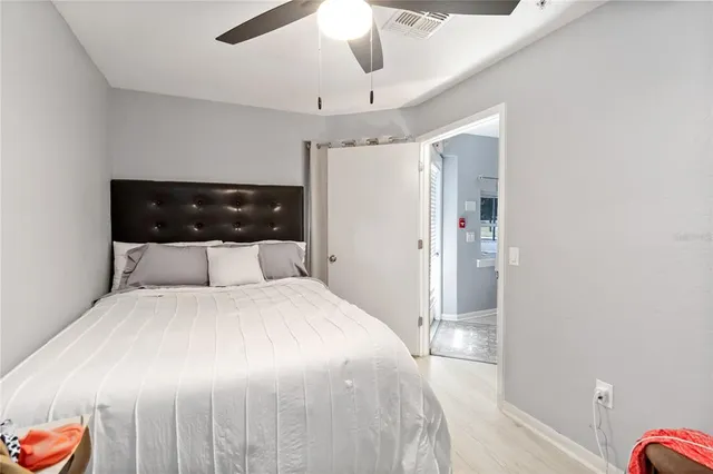 a bedroom with a large bed and a chandelier