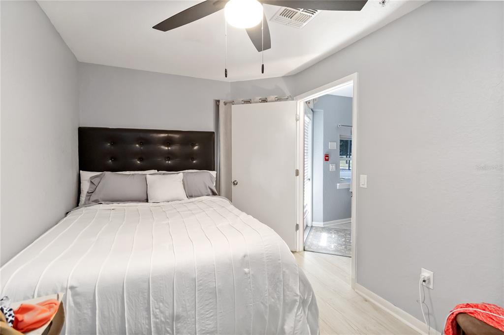 395 Piney Ridge Road Casselberry, FL 32707 - Photo 30 of 34 a bedroom with a large bed and a chandelier