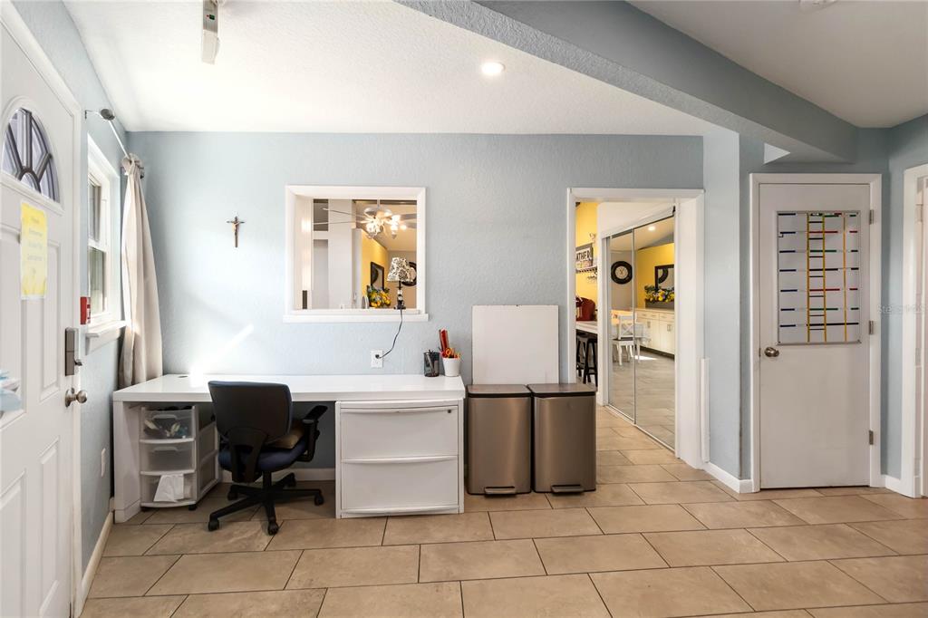 395 Piney Ridge Road Casselberry, FL 32707 - Photo 4 of 34 a room that has a chair and a table in it with wooden floor