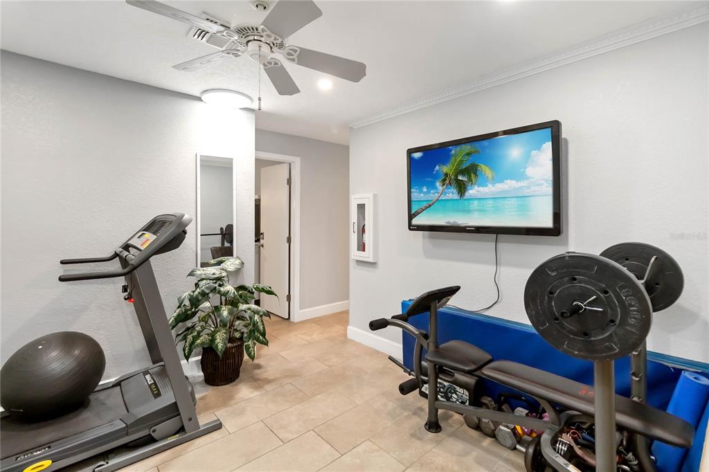 395 Piney Ridge Road Casselberry, FL 32707 - Photo 9 of 34 a view of a workspace with furniture and gym equipment