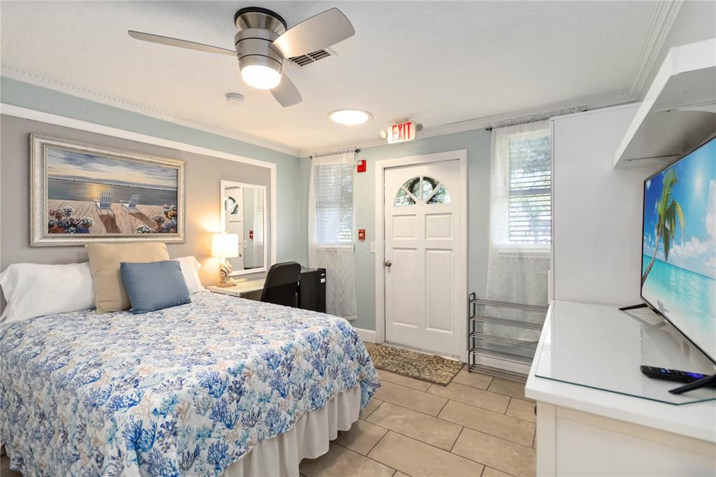 395 Piney Ridge Road Casselberry, FL 32707 - Photo 10 of 34 a bedroom with a bed and a flat tv screen on the dresser