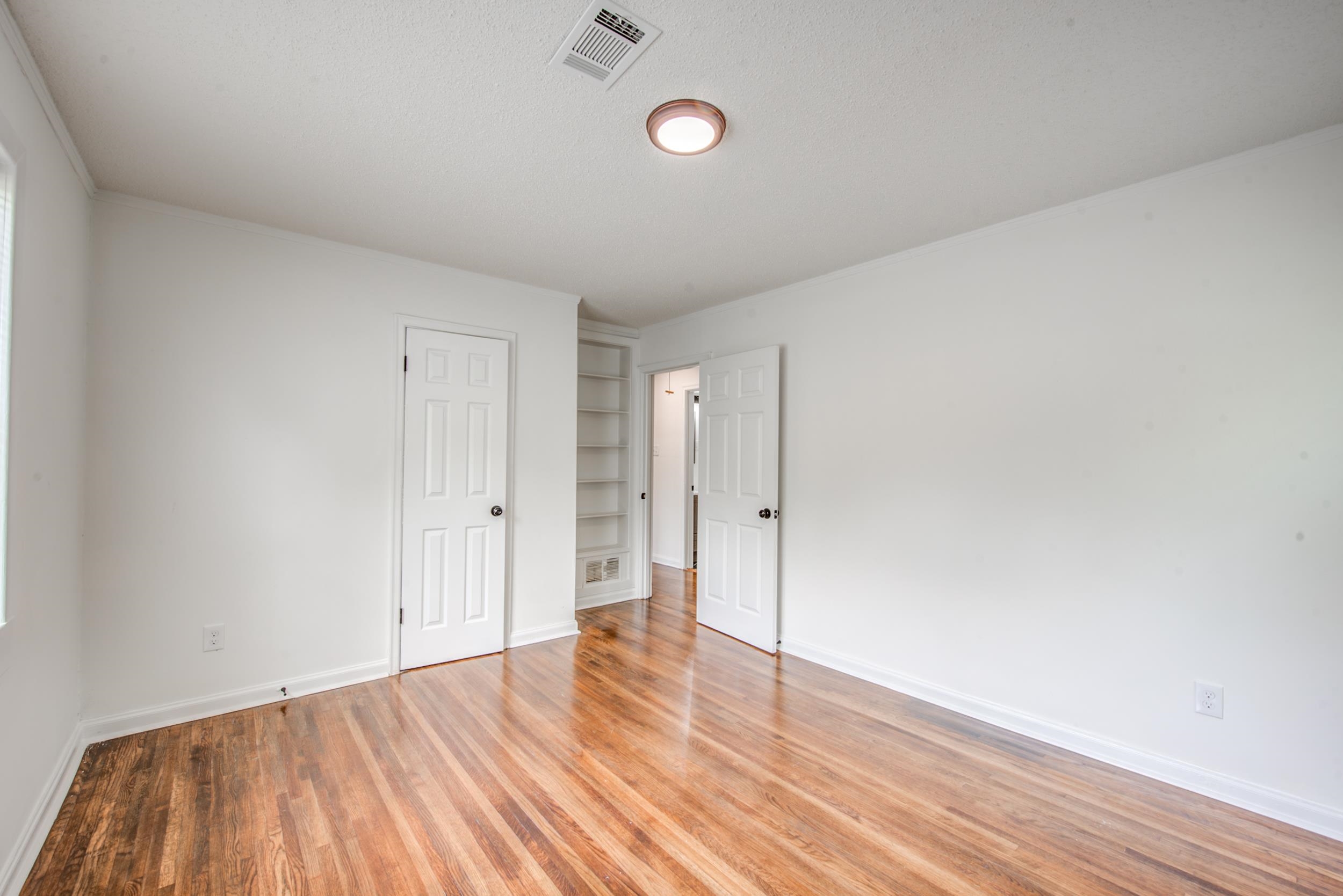 1334 South Perkins Road Memphis, TN 38117 - Photo 14 of 21 a view of an empty room and wooden floor