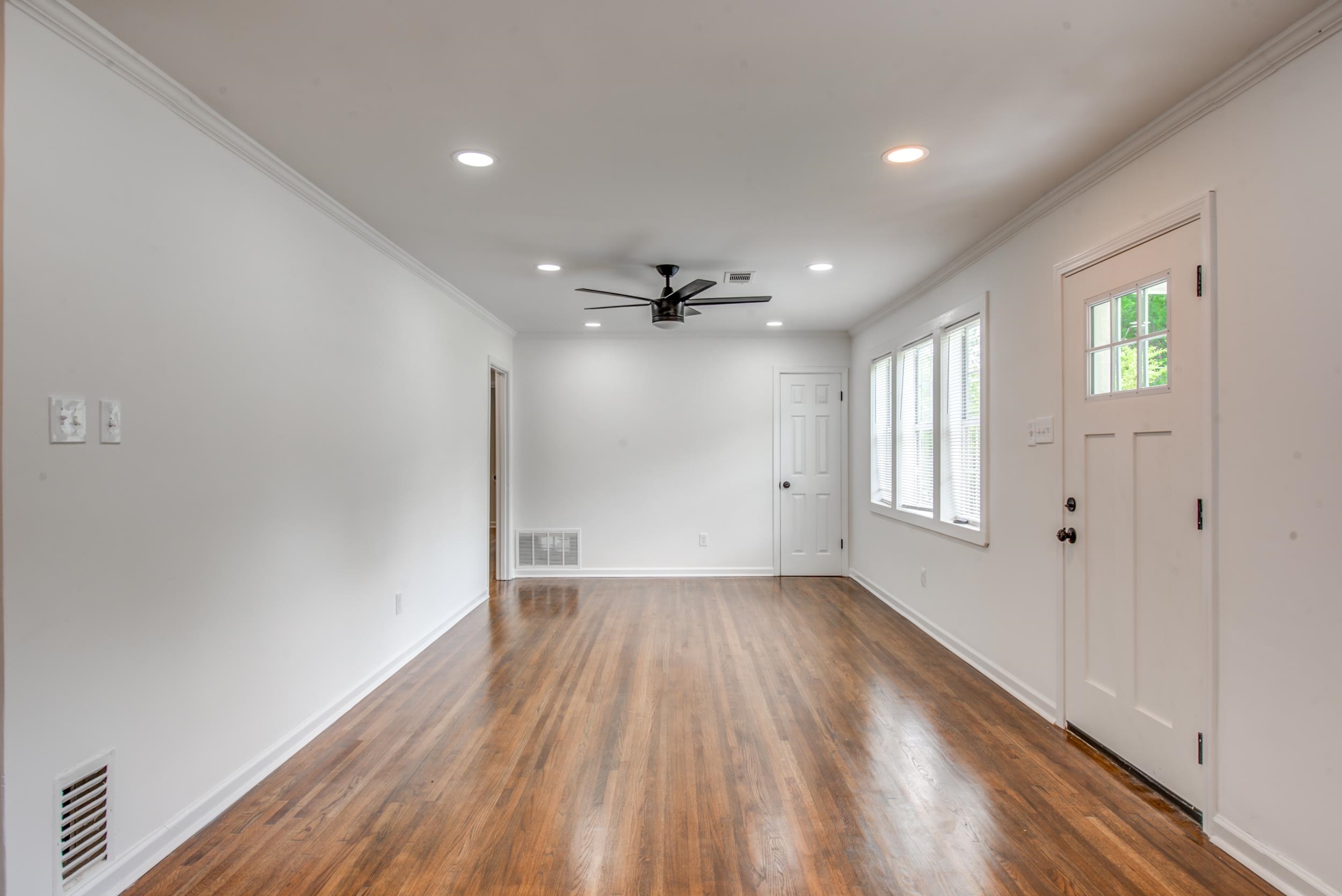 1334 South Perkins Road Memphis, TN 38117 - Photo 3 of 21 wooden floor in an empty room with a window
