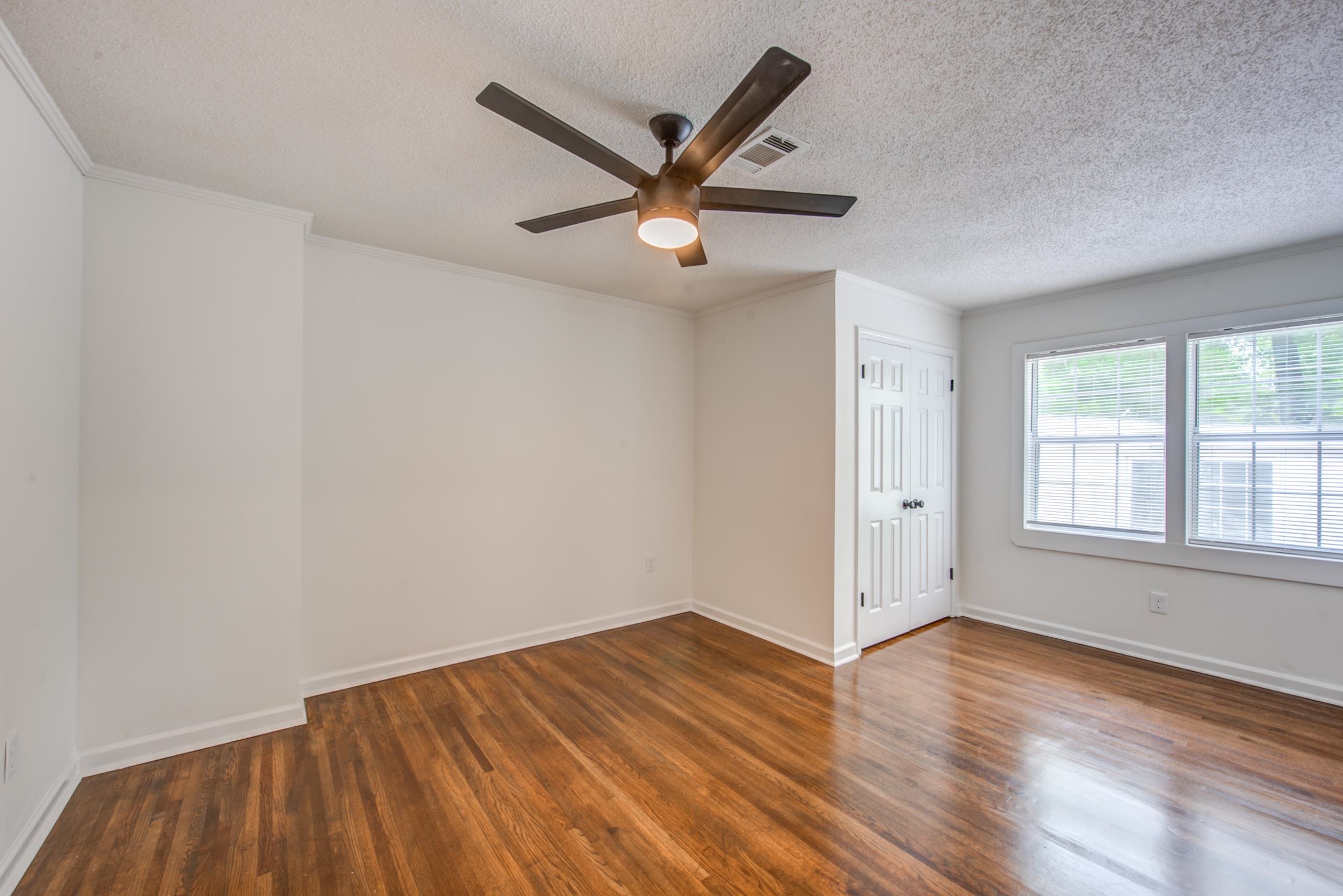 1334 South Perkins Road Memphis, TN 38117 - Photo 5 of 21 wooden floor in an empty room with a window