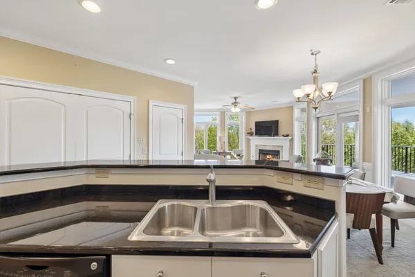 a bathroom with a granite countertop bathtub shower sink vanity and toilet