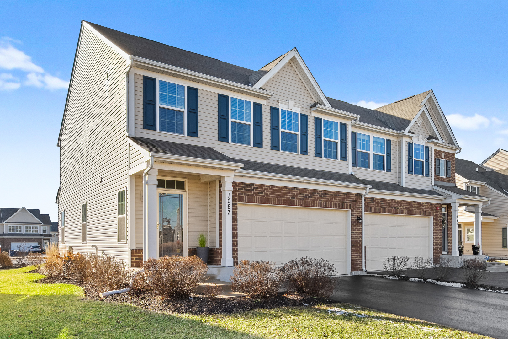 a front view of a house with a yard and garage