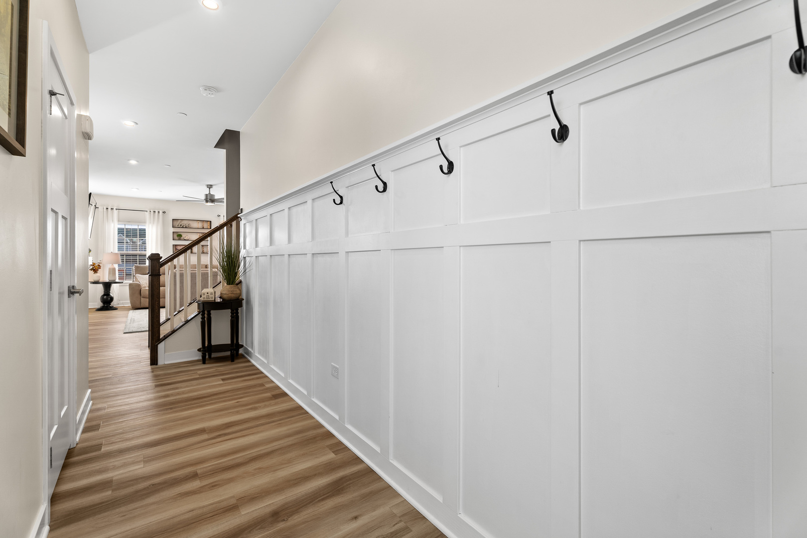 1053 Sears Circle Elburn, IL 60119 - Photo 11 of 31 a view of a hallway with wooden floor and staircase