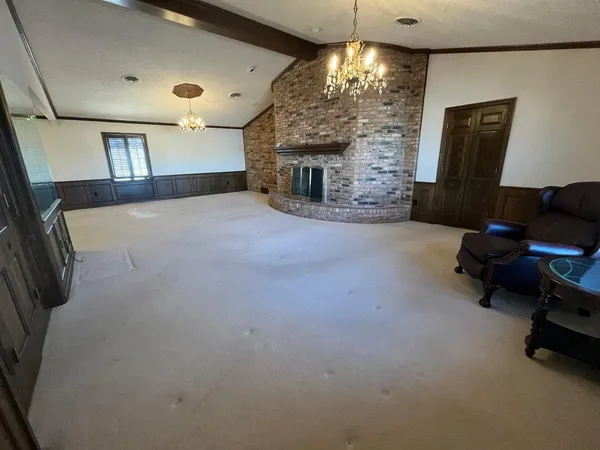 a view of empty room with a fireplace