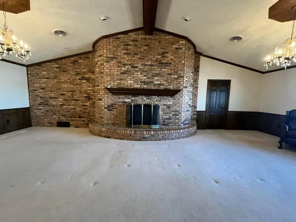a large kitchen with kitchen island granite countertop a sink stove and refrigerator