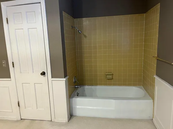 a bathroom with a bathtub and shower