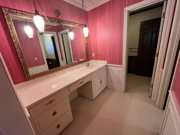 a bedroom with a bed and a mirror