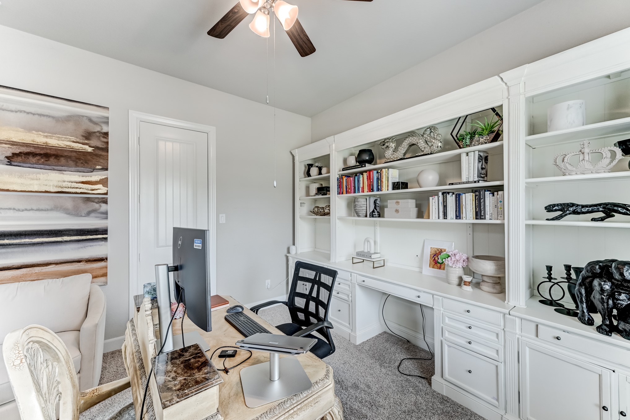 5806 Metaphor Way Rosenberg, TX 77469 - Photo 19 of 50 a kitchen with stainless steel appliances white cabinets and a wooden floor