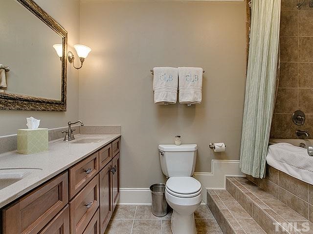 609 Ortega Road Raleigh, NC 27609 - Photo 18 of 25 a bathroom with a toilet sink and mirror