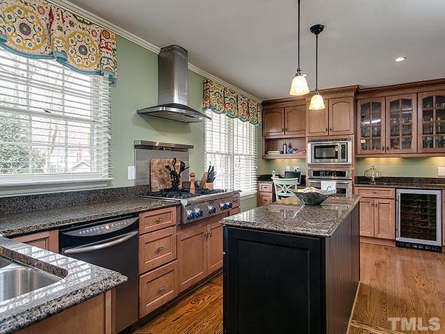 609 Ortega Road Raleigh, NC 27609 - Photo 4 of 25 a kitchen with granite countertop stainless steel appliances a stove sink and microwave