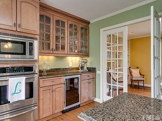 609 Ortega Road Raleigh, NC 27609 - Photo 6 of 25 a kitchen with stainless steel appliances granite countertop a stove a sink and a microwave
