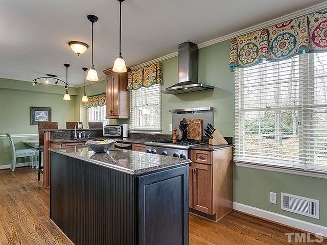 609 Ortega Road Raleigh, NC 27609 - Photo 8 of 25 a kitchen with stainless steel appliances granite countertop a sink a stove and a wooden floors