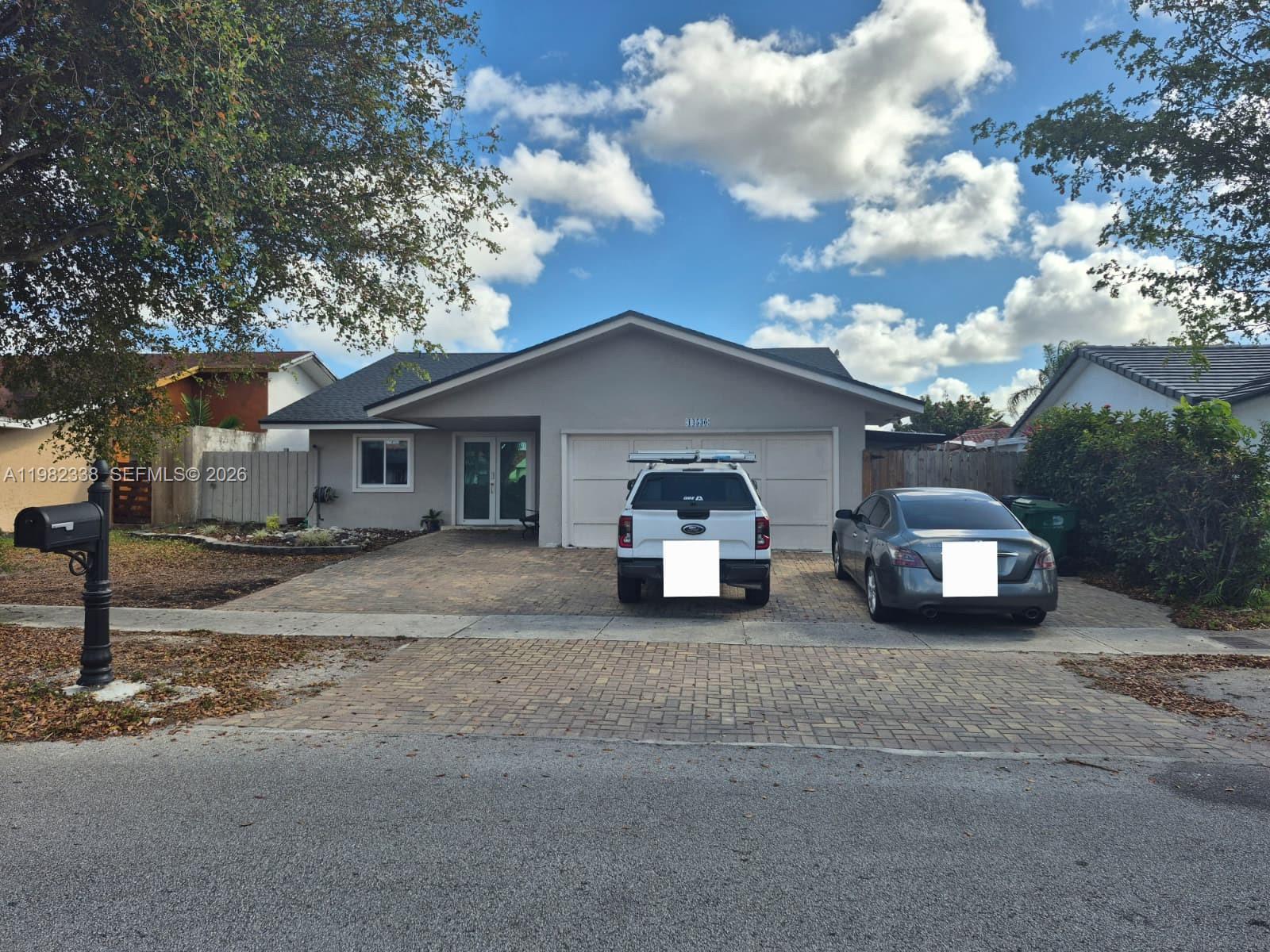 14530 Southwest 110th Street Miami, FL 33186 - Photo 4 of 45 a view of a car parked in front of a house